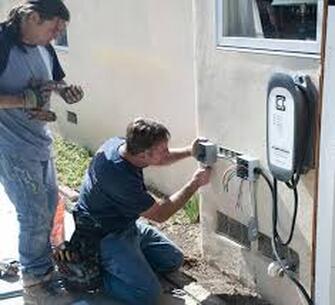 Man installing electric charger for car
