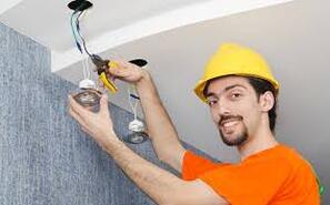 Electrician working on light fixture