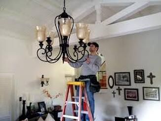 Electrician working on chandelier