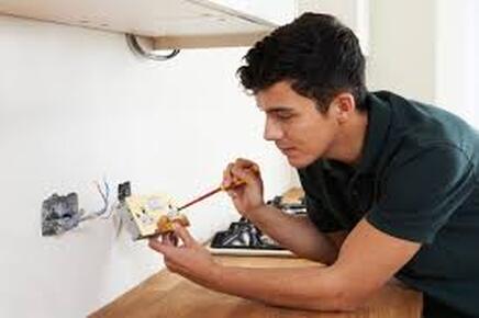Electrician working on light switch